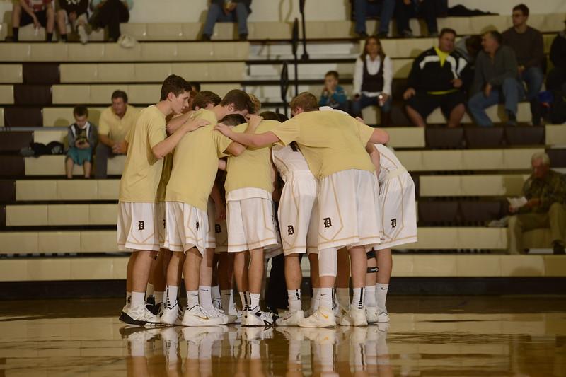 Boys Basketball team huddles to discuss a game in December. 