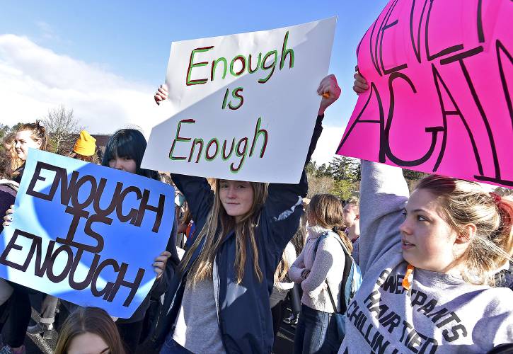 High school students in Astoria, Ore., hold up signs during a walkout Wednesday, March 14, 2018. Students across Oregon left class Wednesday to join a call by young activists for stricter gun laws. (Colin Murphey/Daily Astorian via AP)