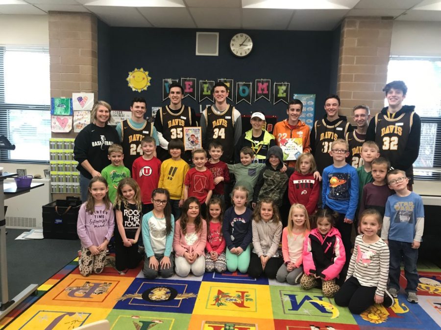 Boys basketball brings books to local elementary