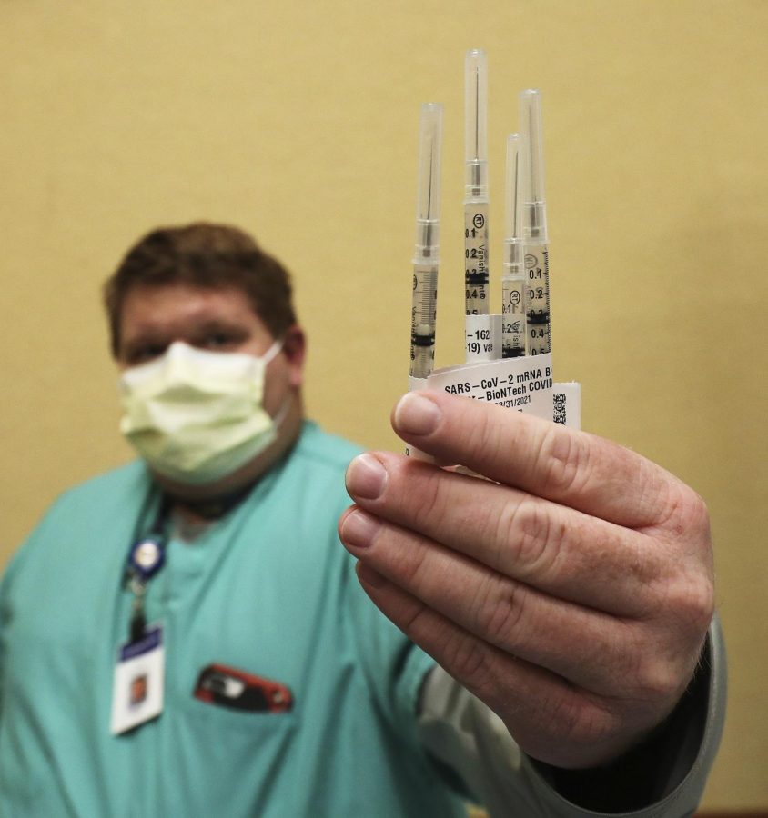 Intermountain Healthcare employee displays the COVID-19 vaccine.