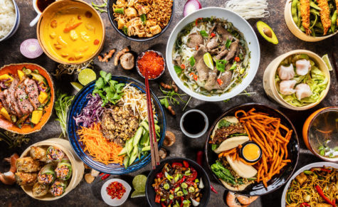 Top view composition of various Asian food in bowls, free space for text